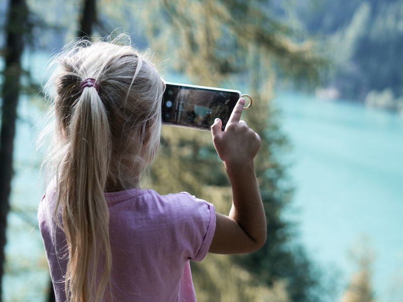 A child taking photo of the water